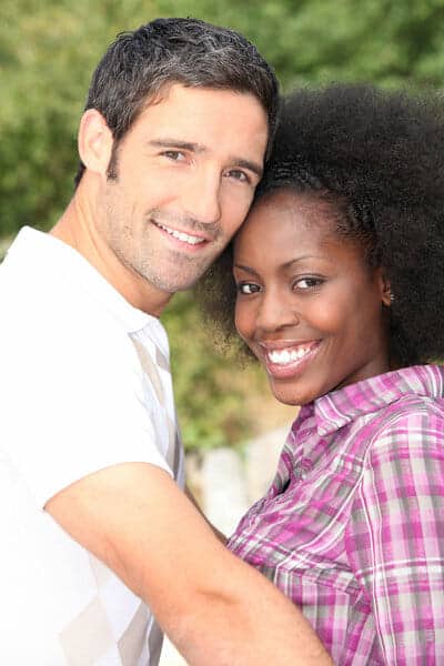 A black man and woman posing for a picture.