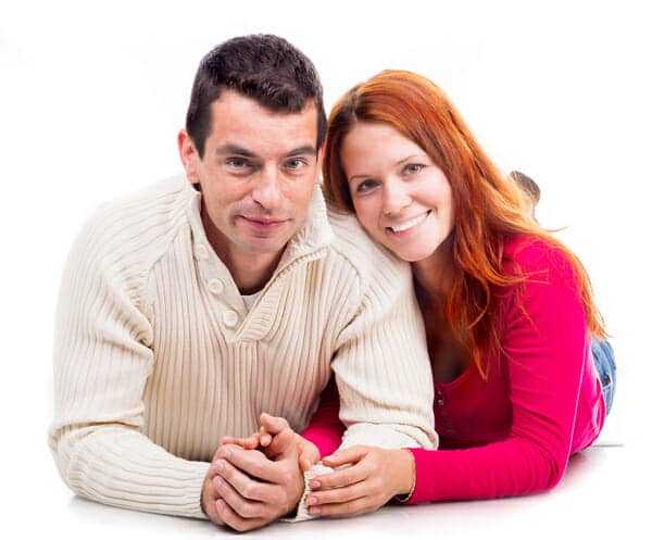 A young man and woman laying on the floor.