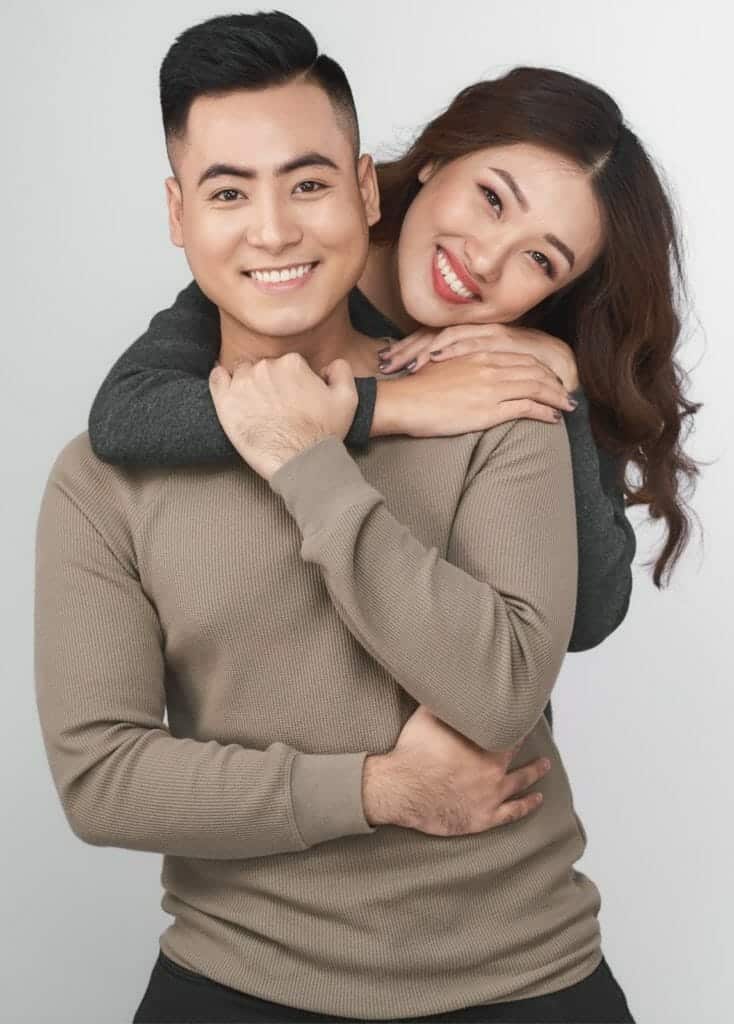 A man and woman hugging while posing for a photo.