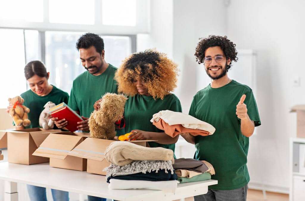 A group of people packing up their belongings in a moving truck.