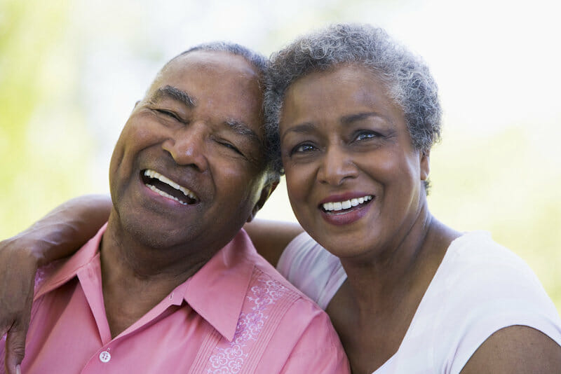 An older couple smiling together.