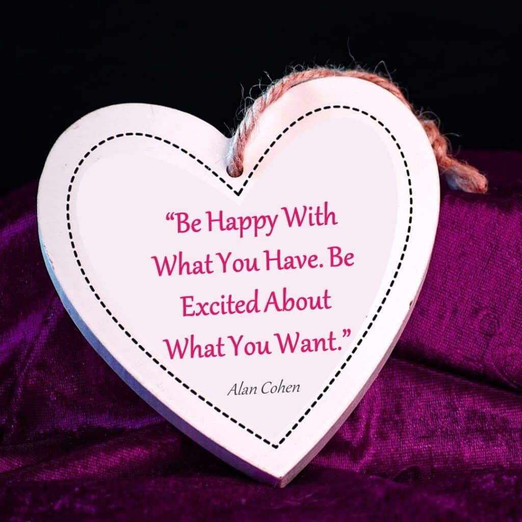 A heart-shaped object with an inspirational quote by alan cohen displayed on a purple background.